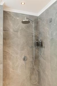 a shower with a glass door in a bathroom at Tranquil Haven in Cape Town +28 photos