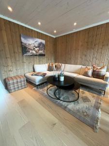 a living room with a couch and a table at Beautiful City Cottage at Geilotunet in Hol