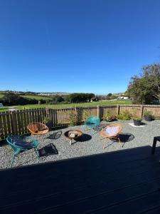 a group of chairs and tables on a patio at The Lodge in Perranporth