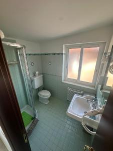 a bathroom with a shower and a toilet and a sink at Villa Lelli 2 in Rome +10 photos