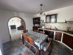 a kitchen with a table and some chairs and a table and a room at Villa Lelli 2 in Rome