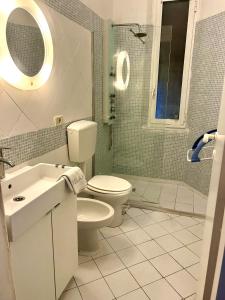 a bathroom with a toilet and a sink and a shower at CASA DI TATJANA in La Spezia