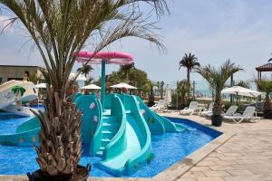 a water slide in a pool at a resort at Apartament Horizon by Alz in Mamaia Sat/Năvodari