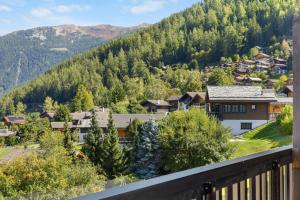 a view from the balcony of a house in the mountains at Arnica 14 - 6 pers - piscine in Nendaz