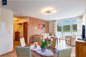 a living room with a couch and a table at Ferienwohnung Strandblick 2 in Ueckeritz