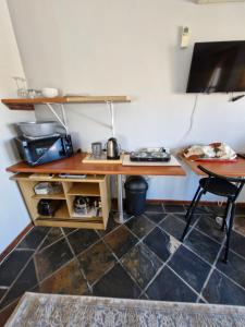 a room with a desk and a table and chairs at 22 on Shiraz 2 in Bellville