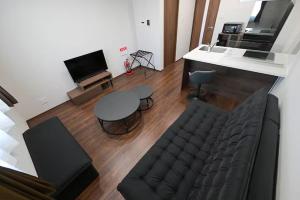 a living room with a couch and a table at LA-CHIC Stay 大津 in Ozu