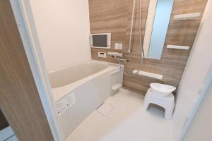 a bathroom with a bath tub and a toilet at LA-CHIC Stay 大津 in Ozu +16 photos