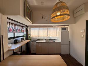 a small kitchen with a sink and a refrigerator at ZEN stay Nikko in Nikko