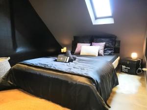 a bedroom with a bed with a laptop on it at Escale Glamour et Chic in Niederbronn-les-Bains