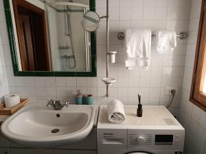 a bathroom with a sink and a washing machine at Casa dell' Onda 25 in Siena +11 photos