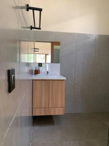 a bathroom with a sink and a mirror at Permata Villas Lombok in Kuta Lombok +17 photos