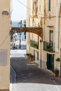 an alley between buildings with the ocean in the background at Francy holiday House NEW at 20 meters from sea in Minori