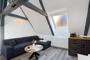 a living room with a couch and a table at Ferienwohnung Sophie in Lauchhammer