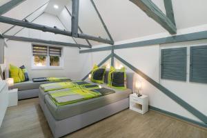 a bedroom with a large bed with yellow pillows at Ferienwohnung Sophie in Lauchhammer