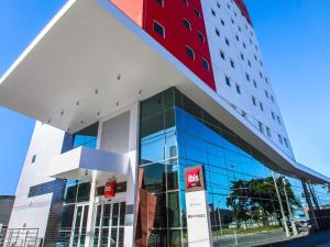 a building with a red and white at ibis Natal in Natal