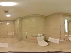 a bathroom with a toilet and a shower and a sink at ibis Natal in Natal +54 photos
