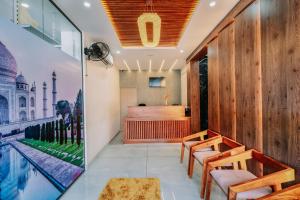 a room with a pool and a bar with wooden walls at Daan Cosmoss Inn, Medical College, Kumarapuram, Trivandrum in Trivandrum