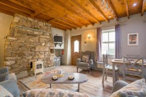 a living room with a stone fireplace and a table at 2 Bed in Wellingtonbridge oc-ii03414 in Nelson Bridge