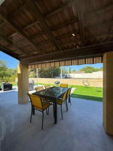 a patio with a table and chairs on a patio at Villa Maeva Florensac in Florensac