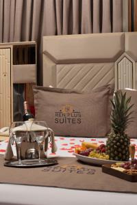 a table with a tray of food and a plate of fruit at REN PLUS SUITES in Istanbul