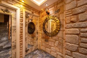 a bathroom with three mirrors on a brick wall at REN PLUS SUITES in Istanbul +61 photos