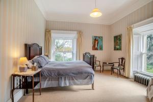 a bedroom with a bed and a table and chairs at 3 Bed in Enniscorthy oc-ii16584 in Enniscorthy