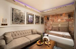 a living room with a couch and a stone wall at REN PLUS SUITES in Istanbul