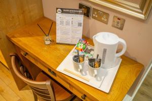 a table with a coffee maker and two cups on it at Marlborough Hotel in Norwich +33 photos