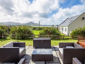 a patio with chairs and tables and a house at 4 Bed in Ballydavid oc-ii16672 in Murreagh