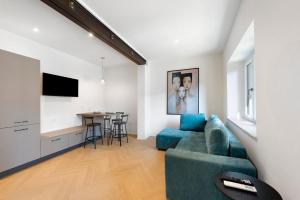 a living room with a blue couch and a table at San Lorenzo Apartment in Giaveno