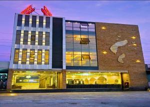 a large building with lights on the front of it at Hotel Imperial in Dabok