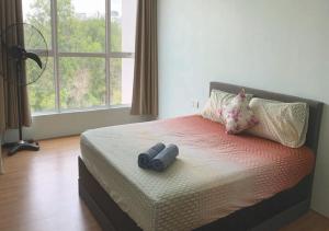 a bedroom with a bed with two binoculars on it at Cozy Hotel Primera Suite Cyberjaya in Cyberjaya +16 photos
