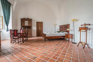 a bedroom with a bed and a table and chairs at zámek Kolštejn - hotel Chateau Goldenstein in Branná