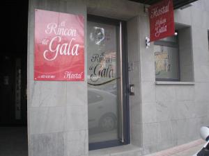 a store with signs in the window of a car at Rincón de Gala in Soria
