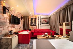 a living room with a red couch and a red sofa at REN PLUS SUITES in Istanbul