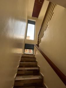 a staircase in a building with a window at House For Rent In Rusororo fully furnished in Kigali