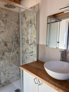 a bathroom with a sink and a shower at Spigolo Nord in Bellano
