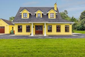 a yellow house with a black roof at 5 Bed in Westport oc-ii06251 in Aghagower +8 photos