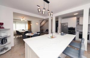 a kitchen and living room with a white counter top at Casa Ligia Casa din inima Branului! in Bran +9 photos