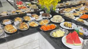 a buffet with many plates of food on a table at HOTEL VIZON II in Vilhena