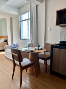 a small living room with a table and chairs at Iara & Muira Apartments in Belém