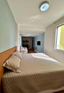 a bedroom with a bed and a window at Iara & Muira Apartments in Belém +28 photos