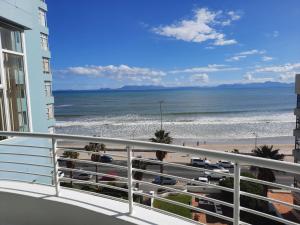 a view of the beach from the balcony of a condo at Cap d Azur beachfront apartment in Strand