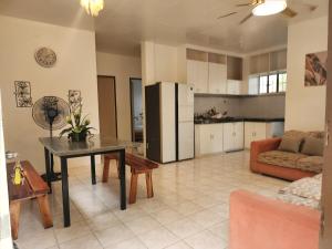 a kitchen and living room with a table and a couch at Casa de Lucas in Moalboal
