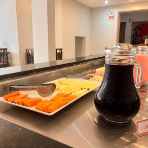 a bottle of soda next to a tray of food at Pousada Bela By Bia - Comfort in Penha
