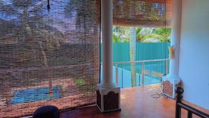 a room with a large window with a view of a pool at Diamond Pool House in Panadura