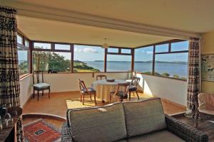 a living room with a table and a view of the ocean at 3 Bed in Duncannon oc-i041 in Duncannon