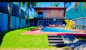 a house with a swimming pool in the yard at Diamond Pool House in Panadura