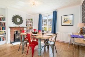 a dining room with a table and chairs and a fireplace at Cherry Tree House in Haverfordwest
